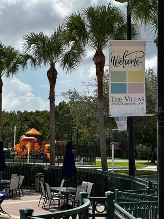 a view of a park with potted plants and palm trees