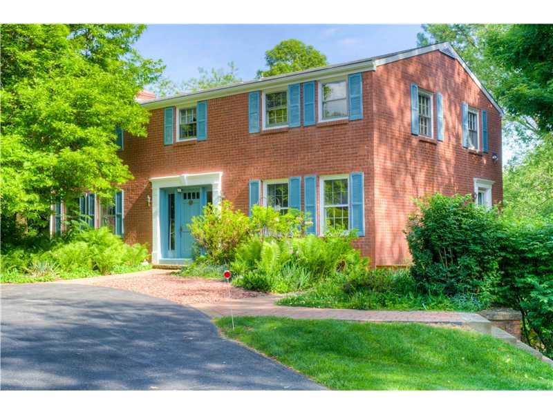 Exterior Front. All brick two story in Pine Township  is situated on over an acre of lush green grass, trees and shrubs.