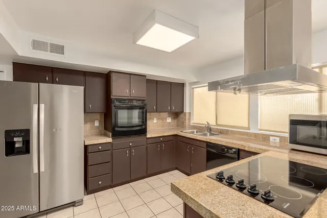 a kitchen with a sink stove and refrigerator