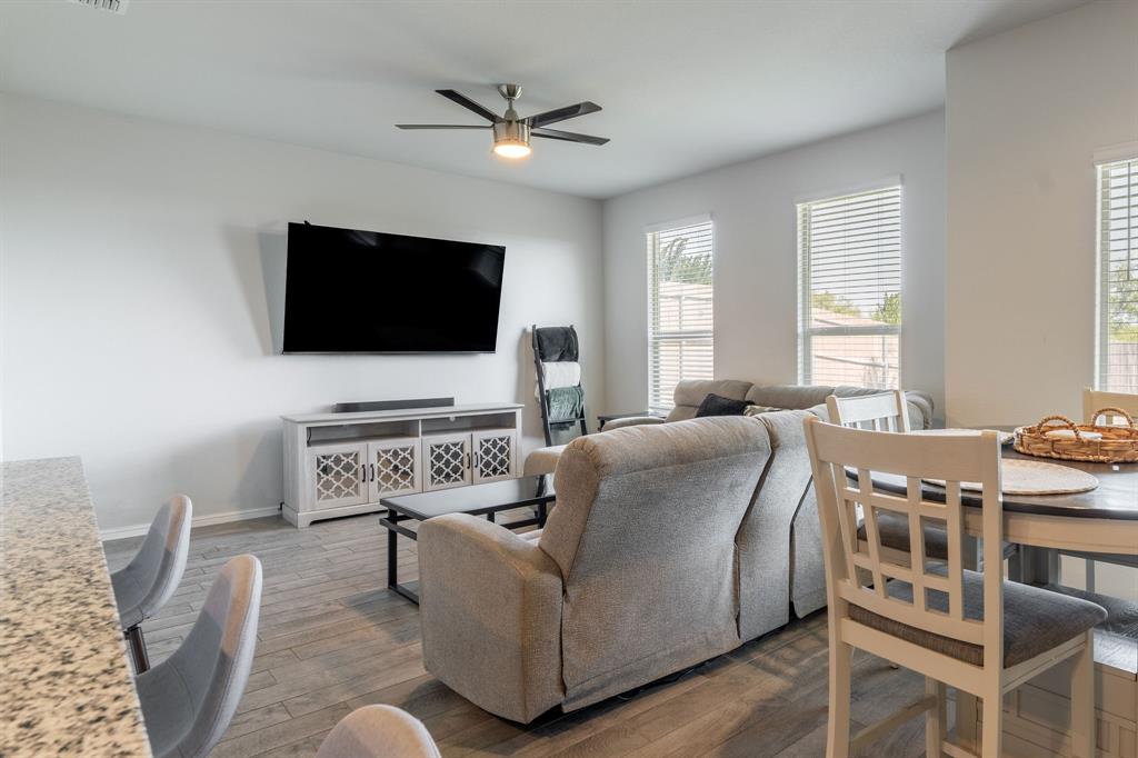 9712 Cherryville Road Fort Worth, TX 76108 - Photo 13 of 27 a living room with furniture and a flat screen tv