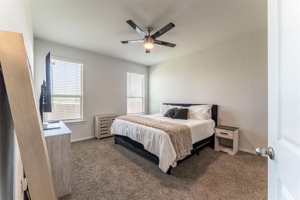 9712 Cherryville Road Fort Worth, TX 76108 - Photo 16 of 27 a spacious bedroom with a bed and window