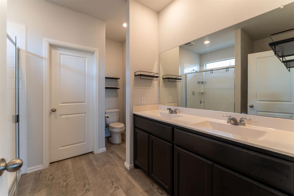 9712 Cherryville Road Fort Worth, TX 76108 - Photo 17 of 27 a bathroom with a double vanity sink and a mirror