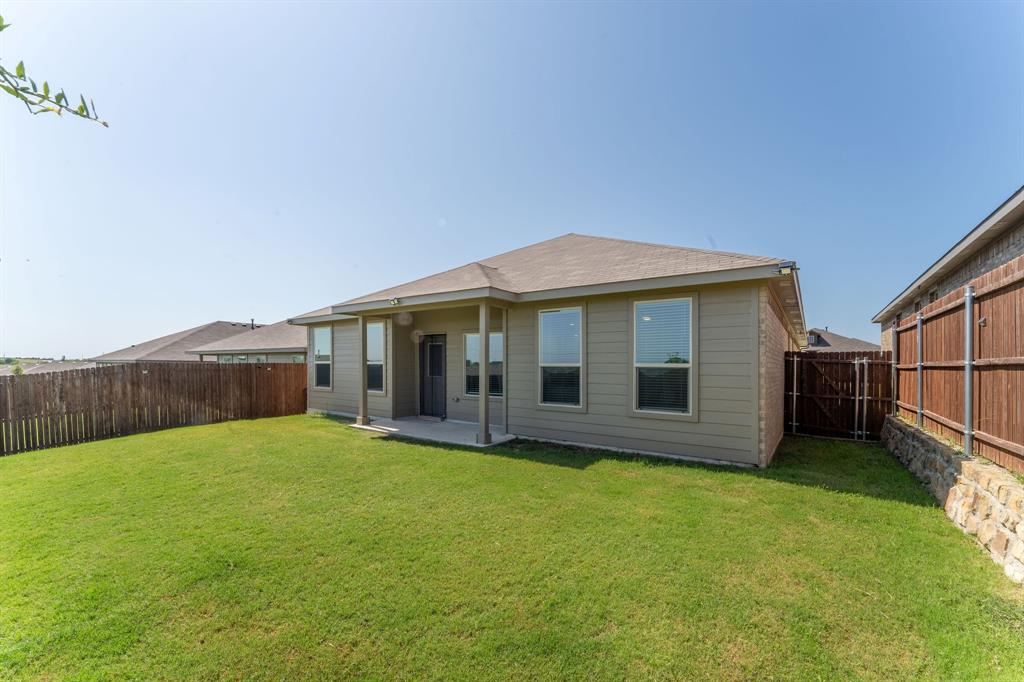 9712 Cherryville Road Fort Worth, TX 76108 - Photo 19 of 27 a view of a house with a yard and sitting area