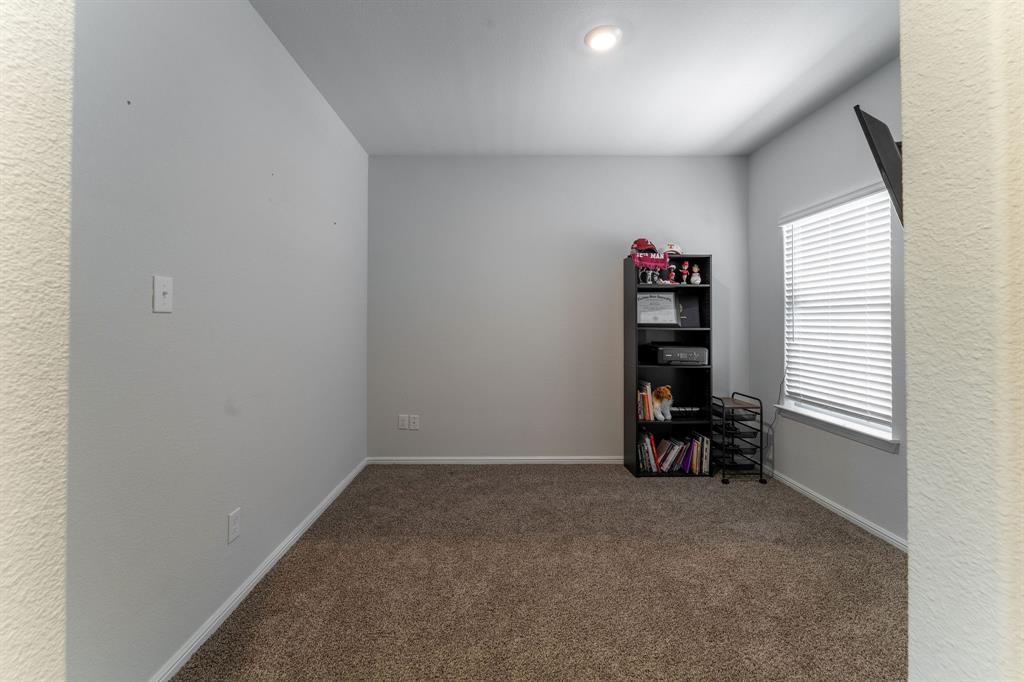 9712 Cherryville Road Fort Worth, TX 76108 - Photo 6 of 27 an empty room with a bench and a window