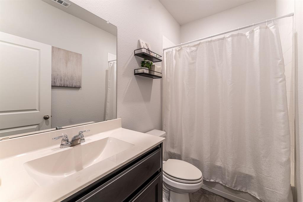 9712 Cherryville Road Fort Worth, TX 76108 - Photo 8 of 27 a bathroom with a sink and a mirror