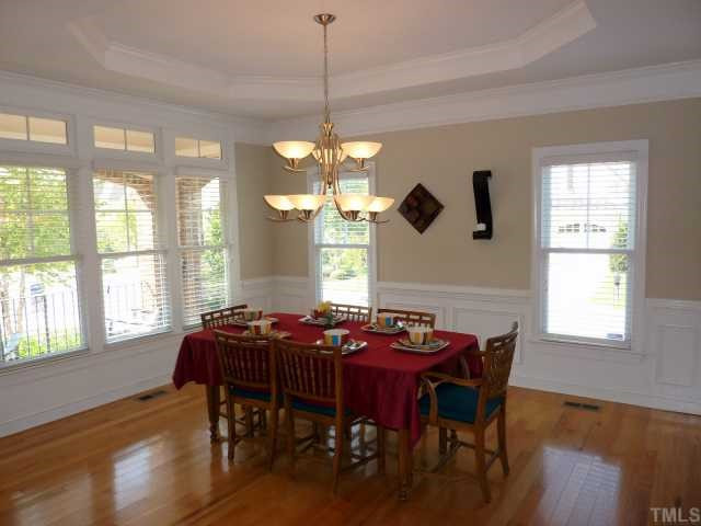 Simply Exquisite! This separate Dining Room is Bright and Airy. The Gorgeous Crown Molding and Wainscoting add to the Elegance of this room. Dining Room