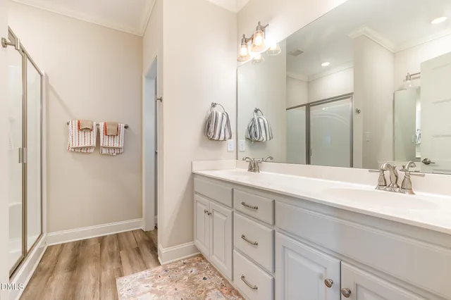 a spacious bedroom with a bed and a flat screen tv