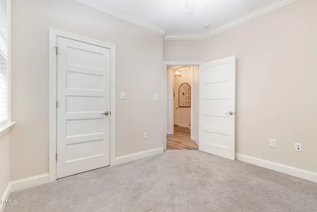 a bedroom with a bed and a potted plant