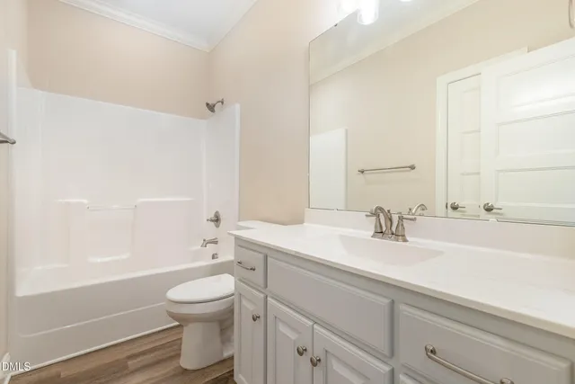 a bedroom with a bed and a potted plant