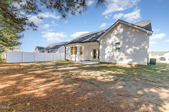 a view of a house with a yard and sitting area