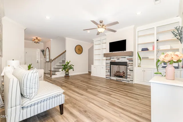 a living room with furniture and wooden floor