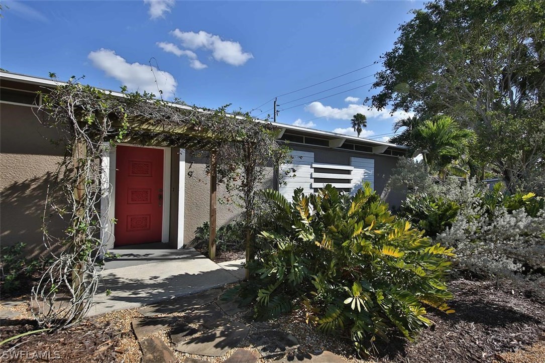 2979 Holly Road Fort Myers, FL 33901 - Photo 1 of 24 a view of a house with a flower garden