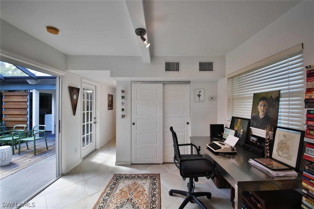 2979 Holly Road Fort Myers, FL 33901 - Photo 13 of 24 a view of a workspace with furniture and a window