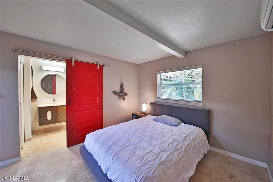 2979 Holly Road Fort Myers, FL 33901 - Photo 15 of 24 a bedroom with a bed and a window