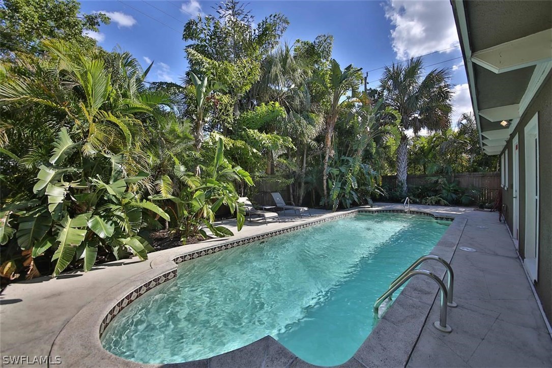 2979 Holly Road Fort Myers, FL 33901 - Photo 21 of 24 a view of a backyard with plants and a fountain