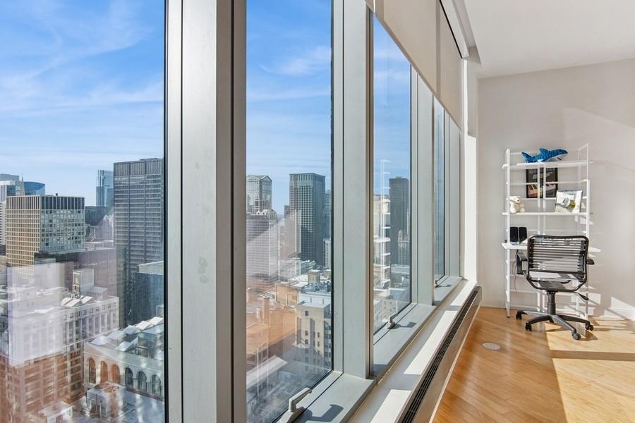 60 East Monroe Street, Unit 4006 Chicago, IL 60603 - Photo 11 of 26 a view of a balcony with chair and floor to ceiling window