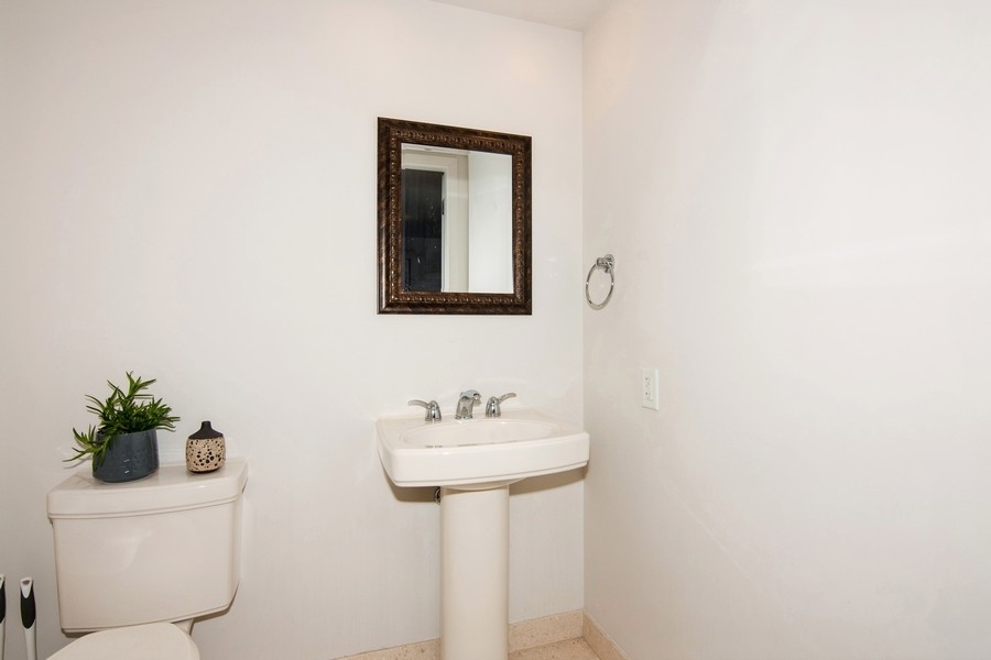 60 East Monroe Street, Unit 4006 Chicago, IL 60603 - Photo 16 of 26 a bathroom with a sink a mirror and a toilet
