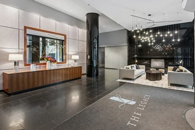 a living room with furniture and large windows