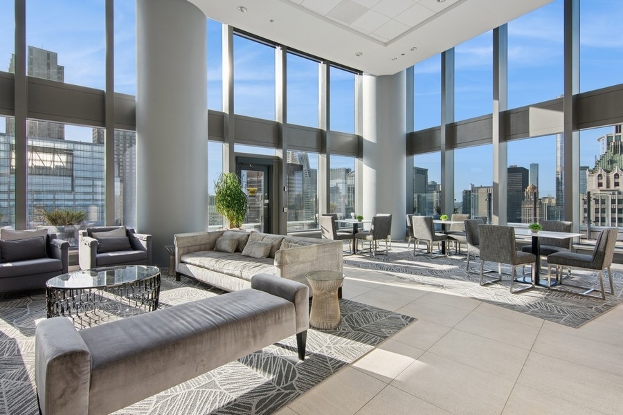 60 East Monroe Street, Unit 4006 Chicago, IL 60603 - Photo 20 of 26 a living room with furniture and large windows