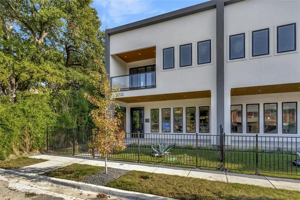 a view of a brick house with large windows
