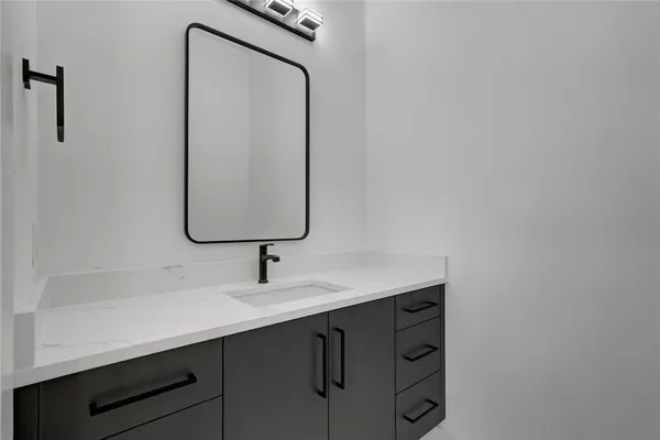 a bathroom with a sink vanity and a mirror