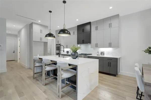 a large kitchen with a table and chairs