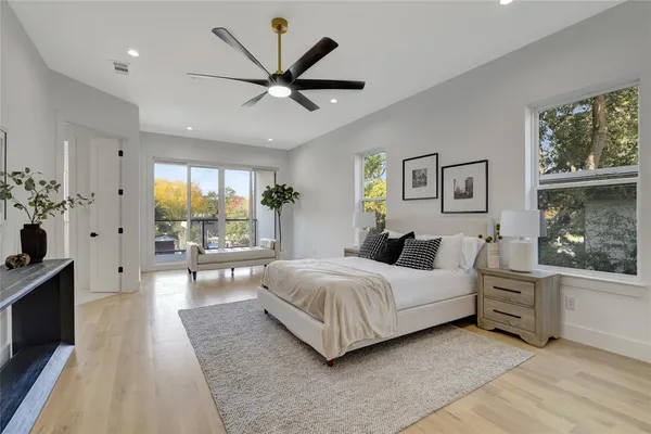 a spacious bedroom with a large bed and a chandelier