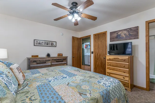 a bedroom with a bed and a chandelier