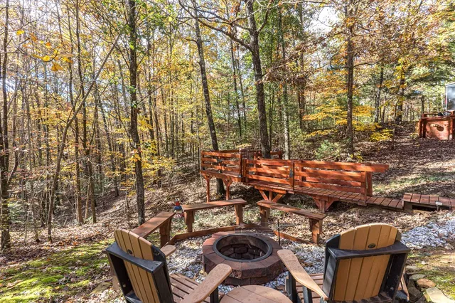 a view of a backyard with table and chairs