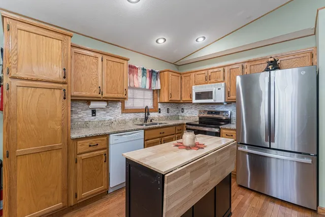 a kitchen with a refrigerator sink and microwave