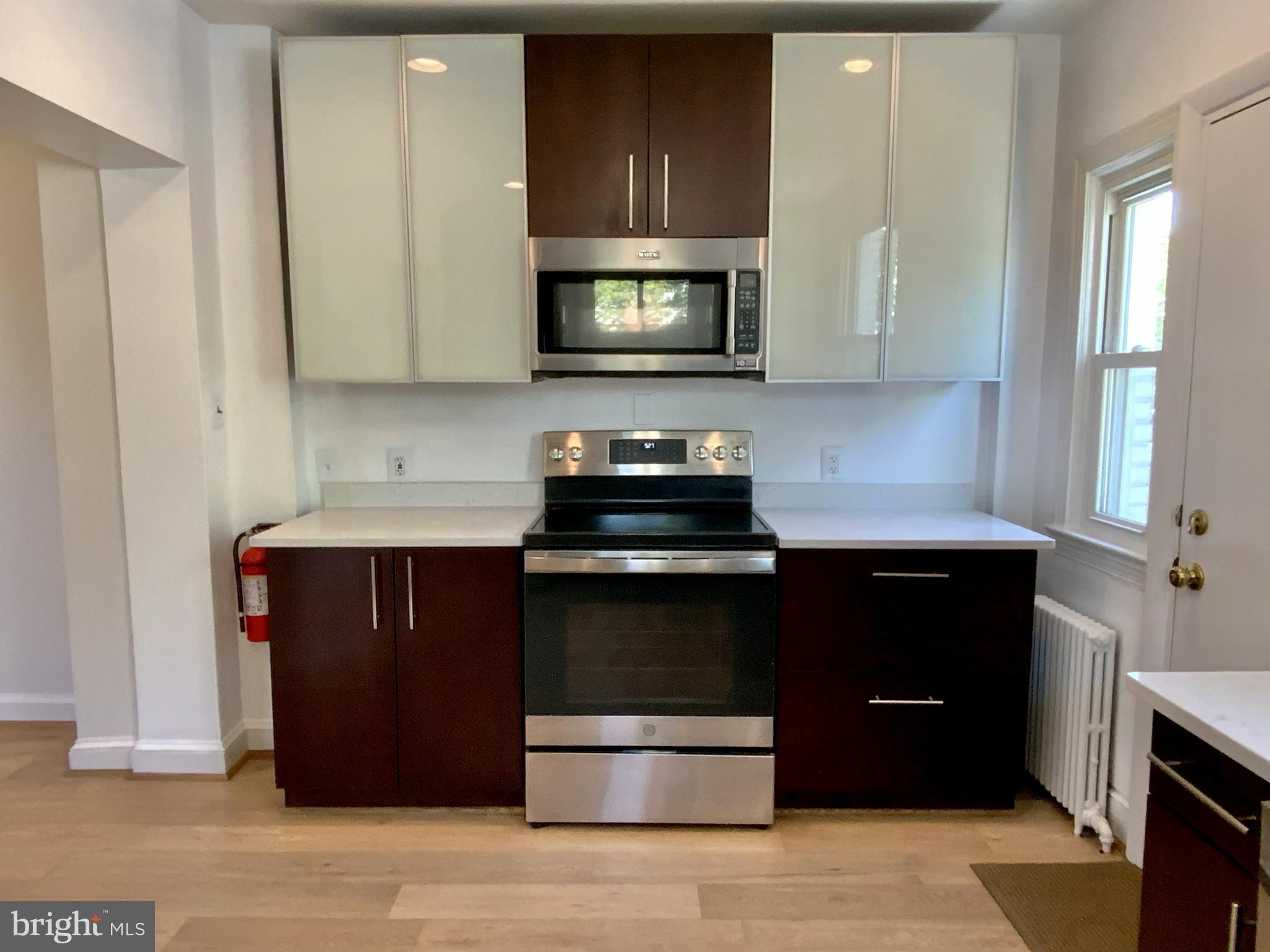 1772 E Street Northeast Washington, DC 20002 - Photo 8 of 23 a kitchen with a stove and a microwave