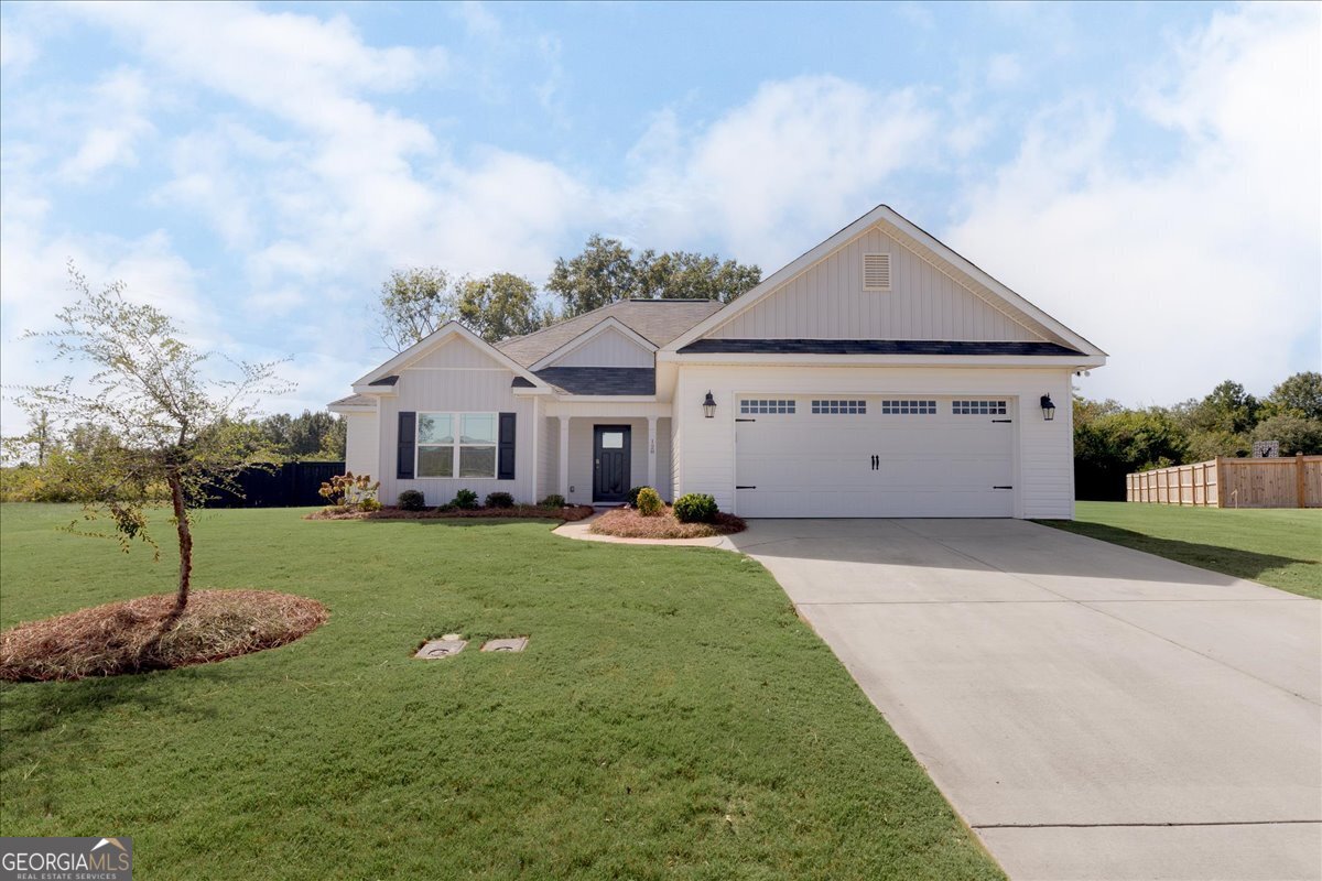 a front view of house with yard and green space