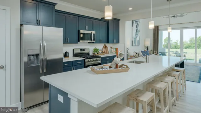 a kitchen with stainless steel appliances granite countertop a sink a stove and a refrigerator