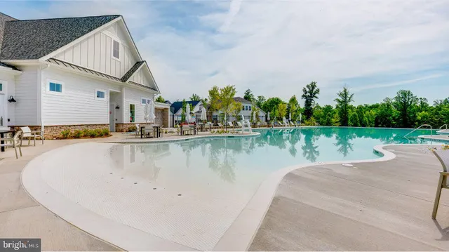 a view of a house with pool and a yard