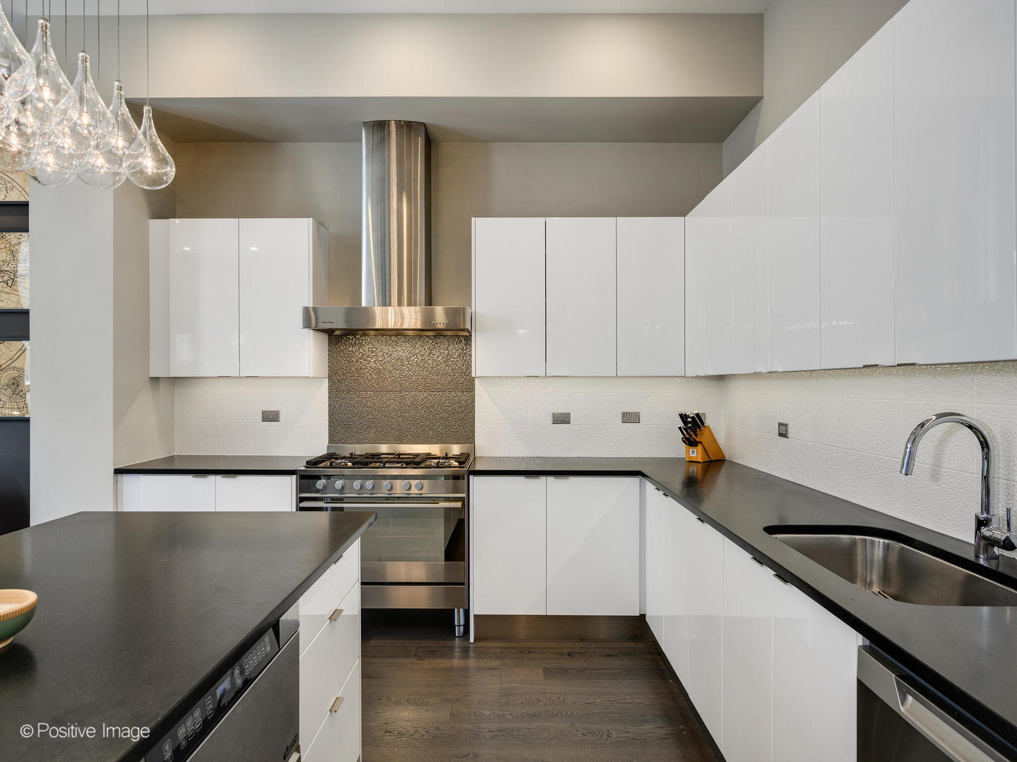 23 North Aberdeen Street, Unit 2N Chicago, IL 60607 - Photo 13 of 29 a kitchen with kitchen island a sink stove and refrigerator