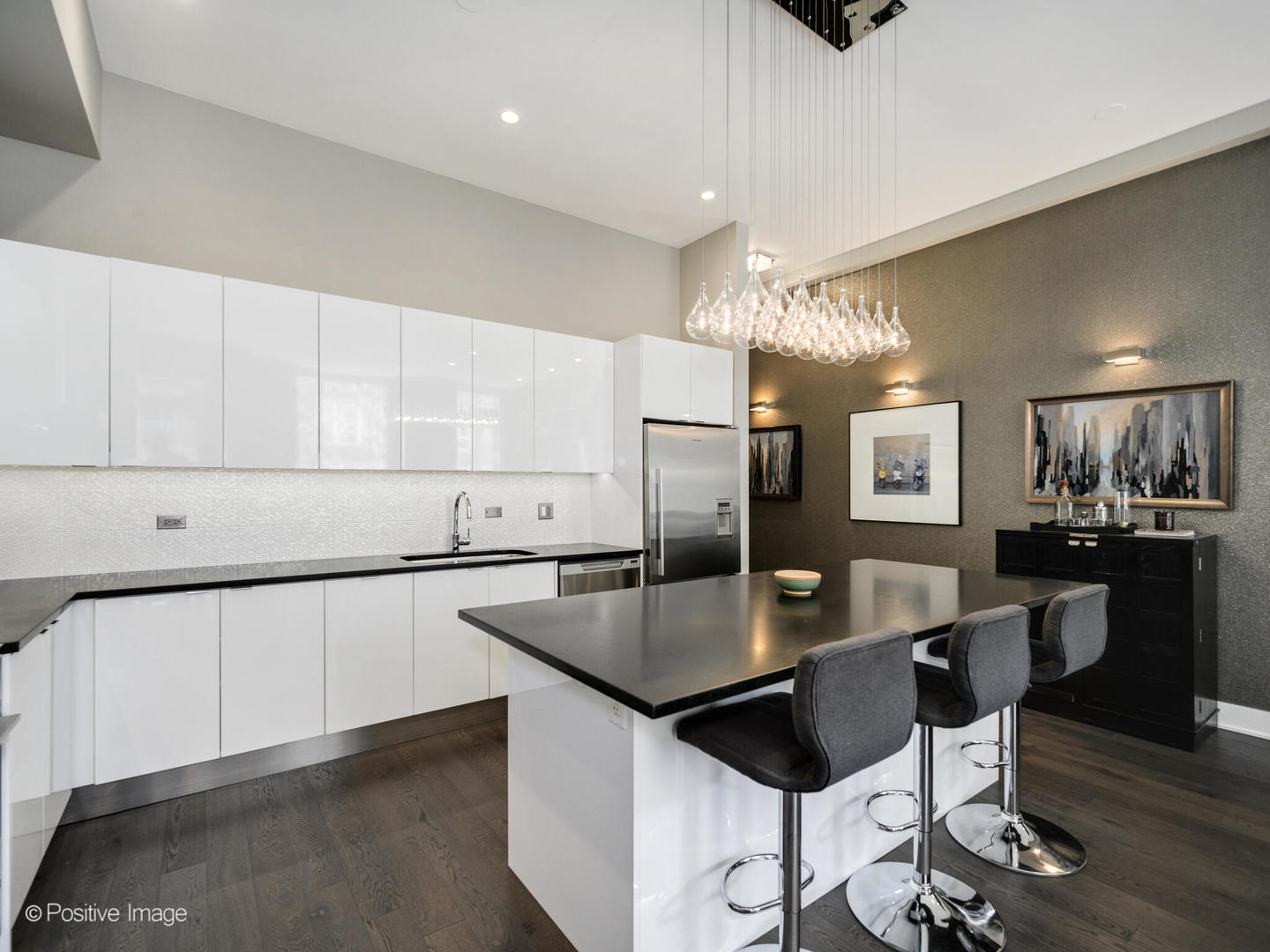 23 North Aberdeen Street, Unit 2N Chicago, IL 60607 - Photo 9 of 29 a kitchen with stainless steel appliances granite countertop a refrigerator a sink a stove a dining table and chairs with wooden floor