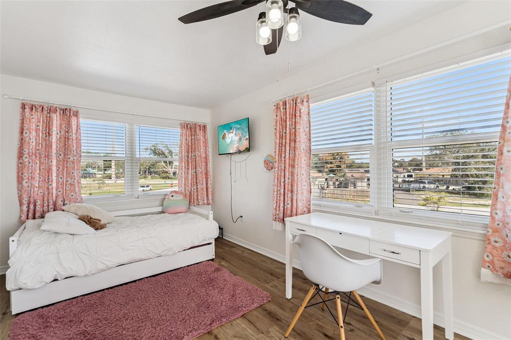 1051 Eva Street Deltona, FL 32725 - Photo 25 of 50 a bedroom with a large bed and a large window