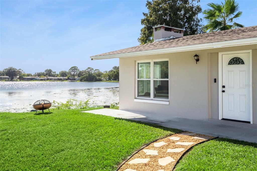 1051 Eva Street Deltona, FL 32725 - Photo 3 of 50 a backyard of a house with table and chairs