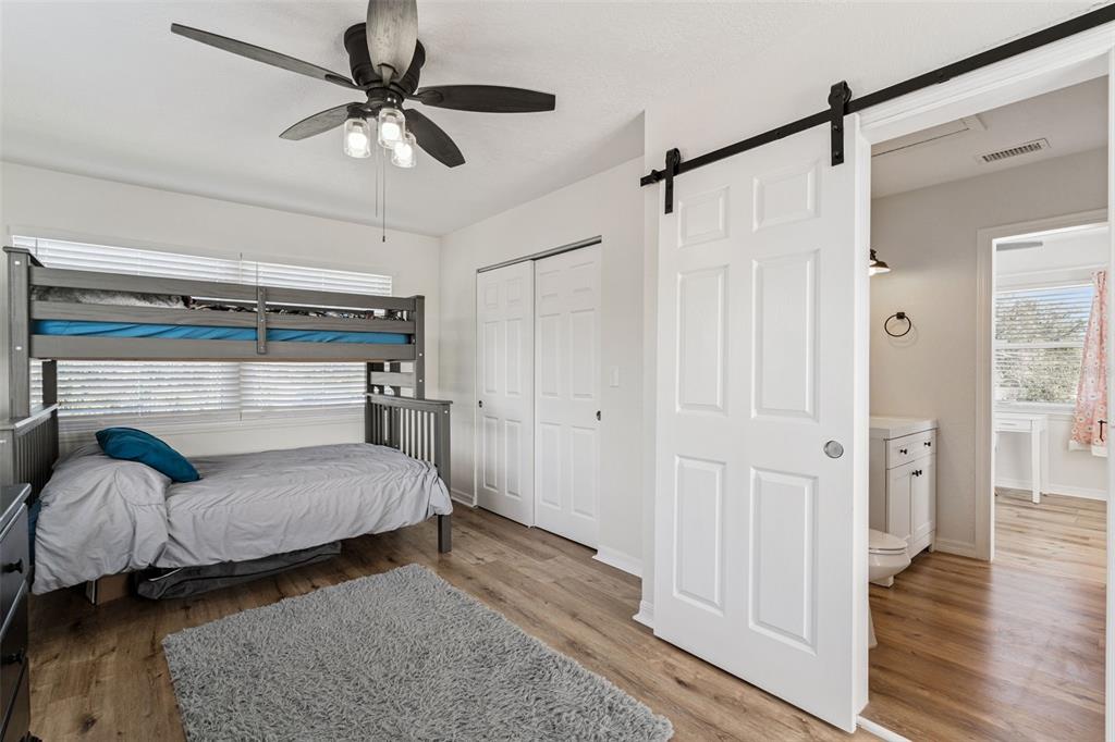 1051 Eva Street Deltona, FL 32725 - Photo 31 of 50 a bedroom with a bed and a ceiling fan