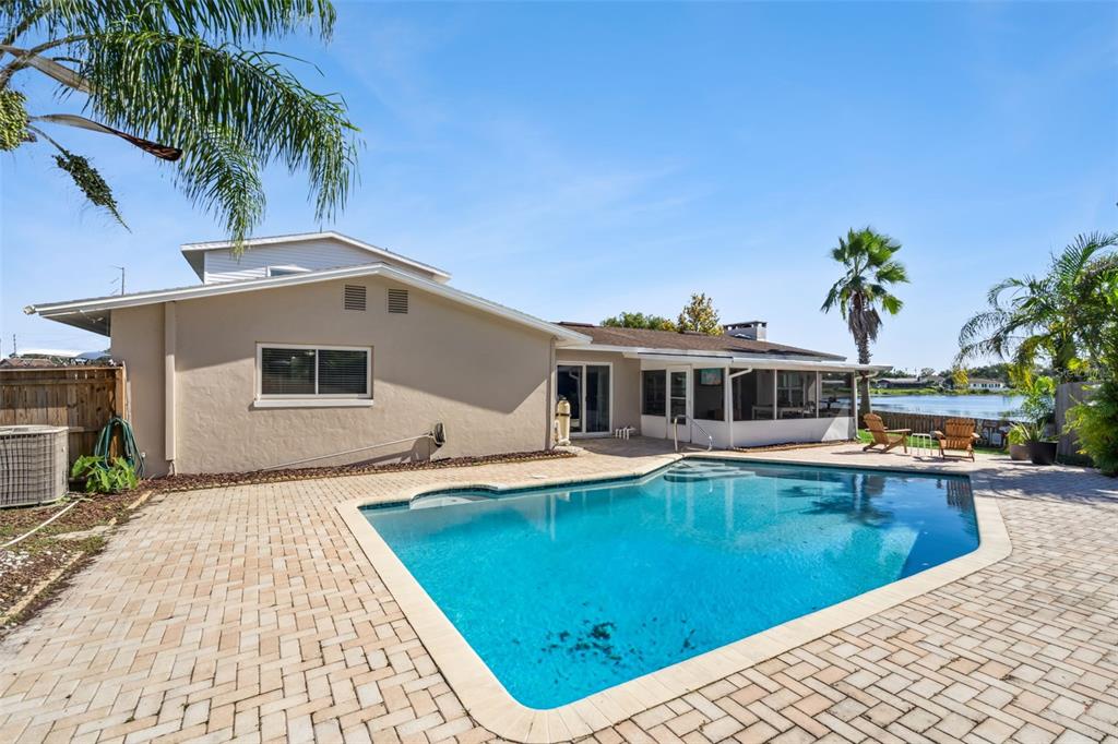 1051 Eva Street Deltona, FL 32725 - Photo 42 of 50 a front view of a house with swimming pool having outdoor seating
