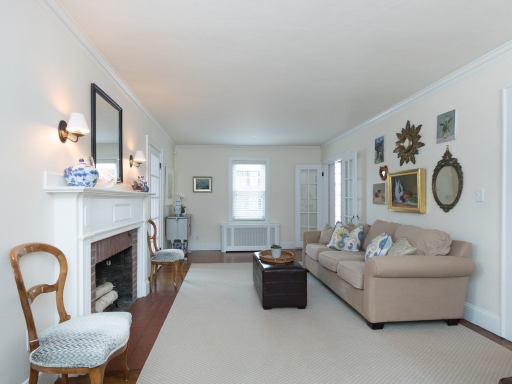 27 Churchill Road Boston, MA 02132 - Photo 12 of 30 a living room with furniture a fireplace and a large mirror