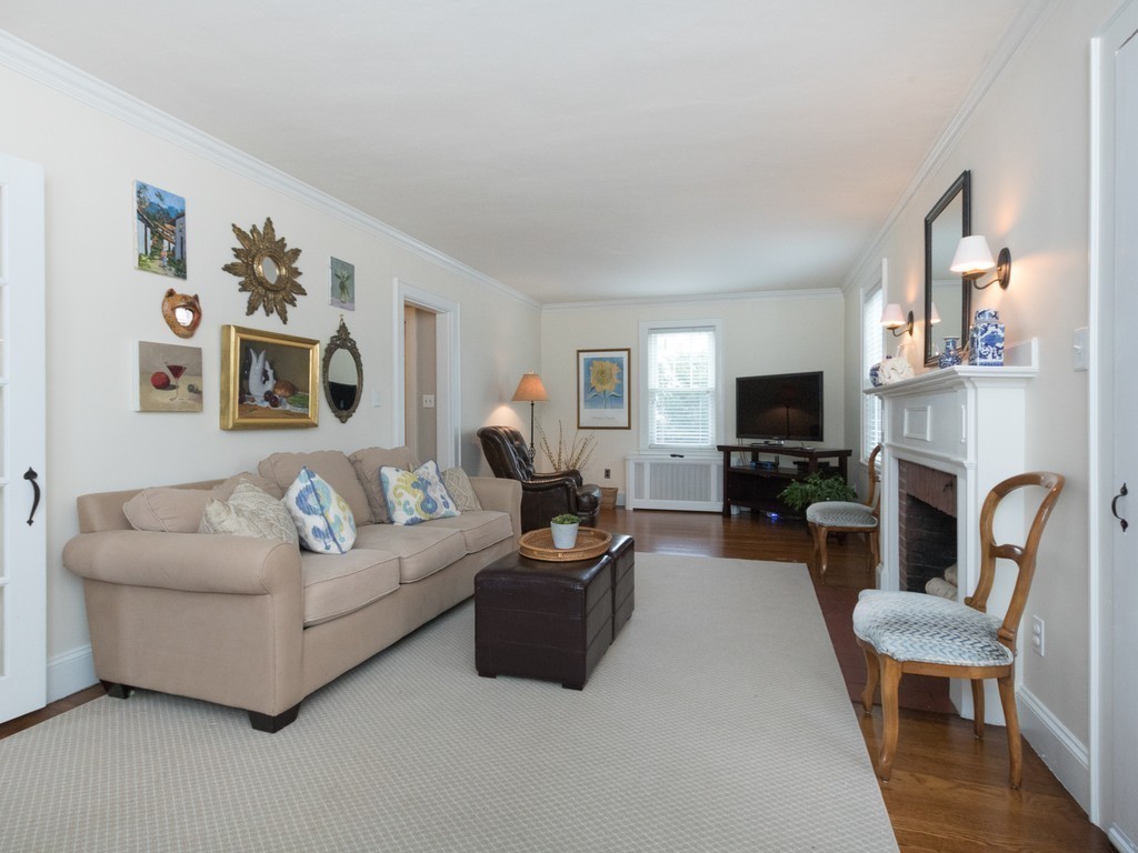 27 Churchill Road Boston, MA 02132 - Photo 13 of 30 a living room with furniture a fireplace and a flat screen tv