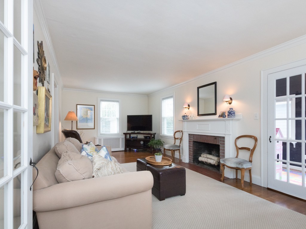 27 Churchill Road Boston, MA 02132 - Photo 15 of 30 a living room with furniture a fireplace and a flat screen tv