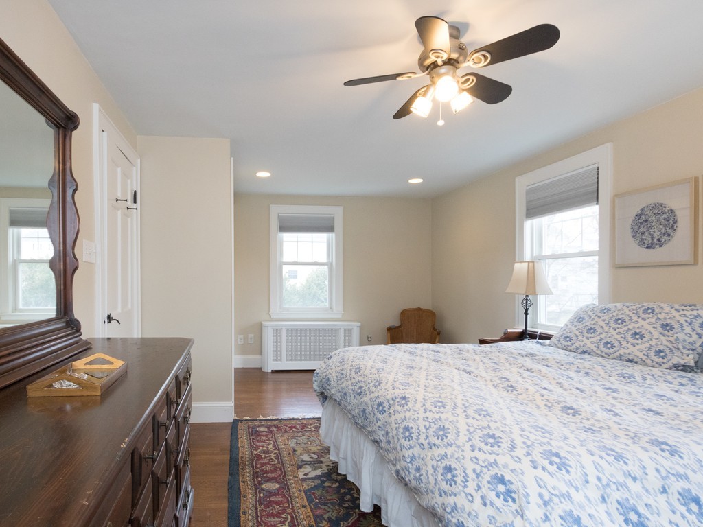 27 Churchill Road Boston, MA 02132 - Photo 19 of 30 a bedroom with a bed and a chandelier