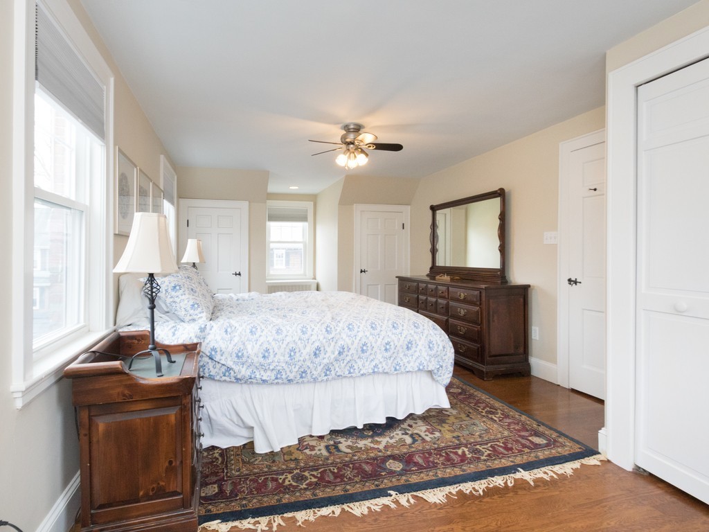 27 Churchill Road Boston, MA 02132 - Photo 20 of 30 a living room with a bed and dresser with mirror