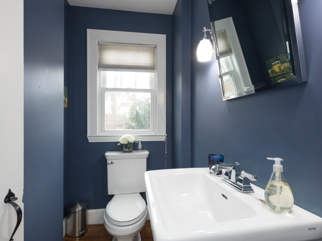 27 Churchill Road Boston, MA 02132 - Photo 25 of 30 a bathroom with a toilet a sink and mirror