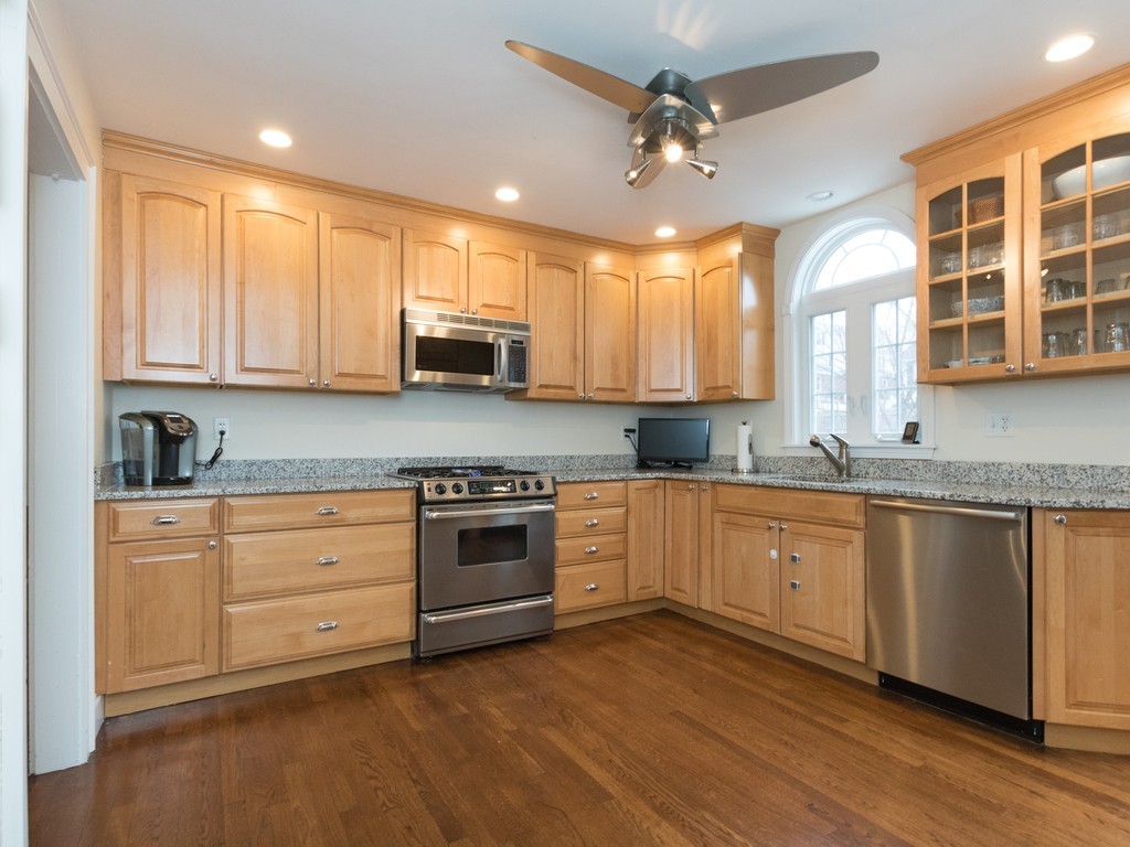 27 Churchill Road Boston, MA 02132 - Photo 5 of 30 a kitchen with stainless steel appliances granite countertop a stove sink and cabinets