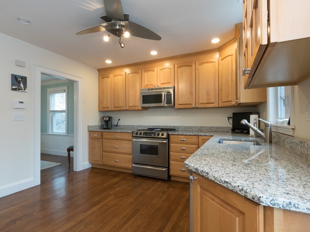 27 Churchill Road Boston, MA 02132 - Photo 6 of 30 a kitchen with stainless steel appliances granite countertop a sink a stove and a wooden floors