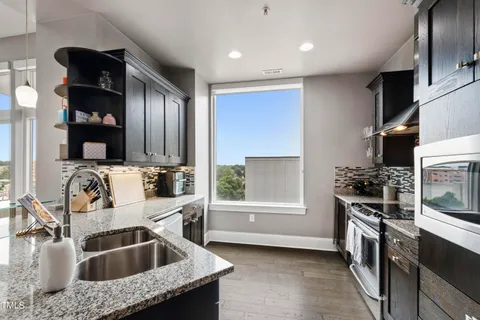 a kitchen that has a sink and a stove