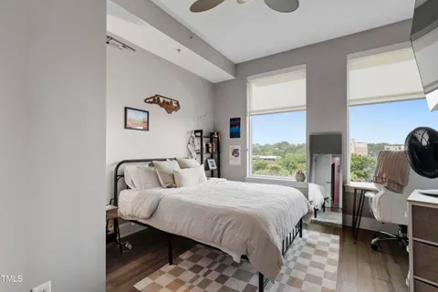 a bedroom with a bed and wooden floor
